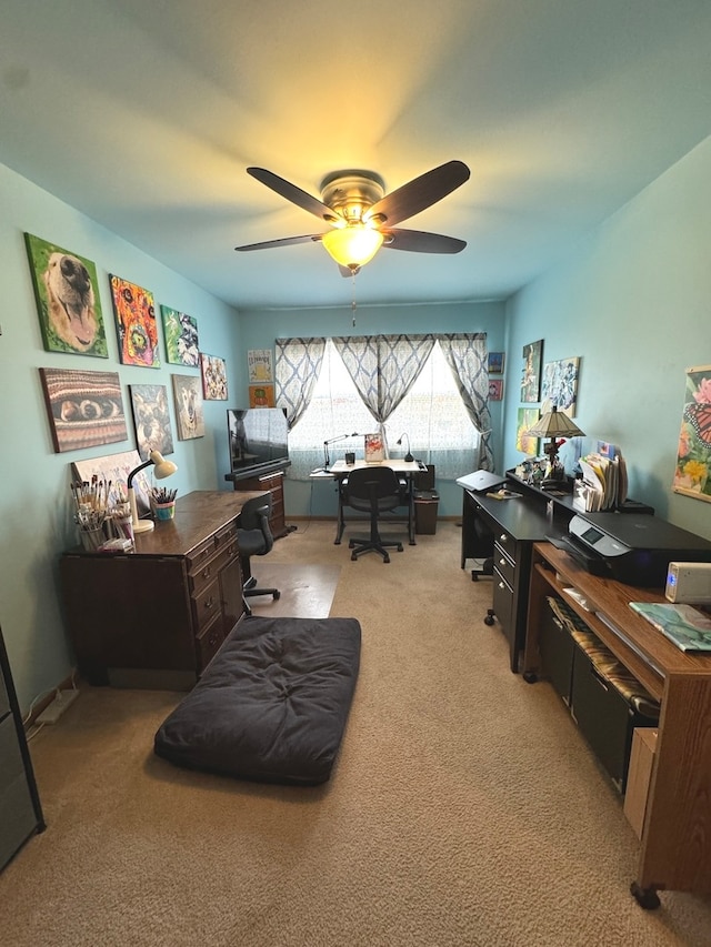 carpeted home office with ceiling fan