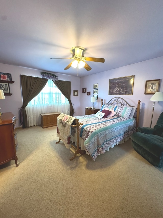 bedroom with ceiling fan and light colored carpet