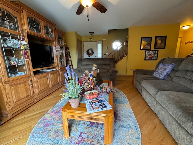 living room featuring light wood-type flooring and ceiling fan