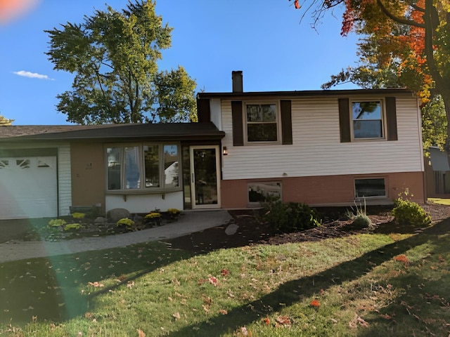 tri-level home with a front lawn and a garage