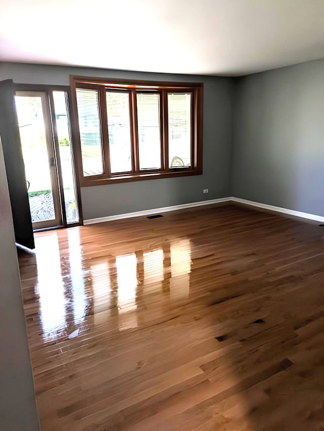 unfurnished room featuring dark wood-type flooring