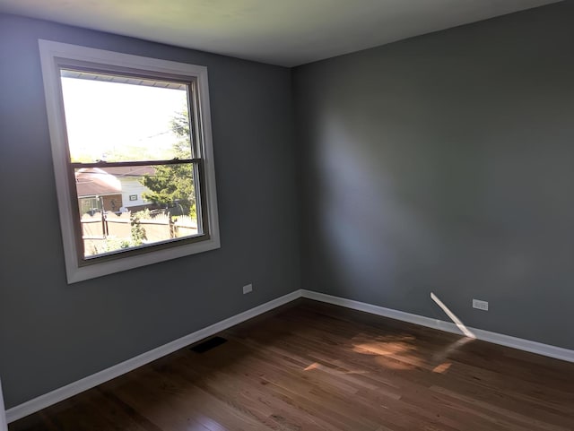 empty room with dark wood-type flooring