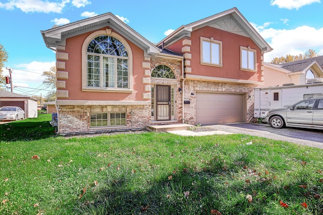 view of front of home with a front yard and a garage