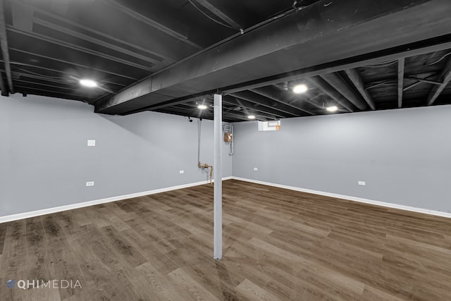 basement with hardwood / wood-style flooring