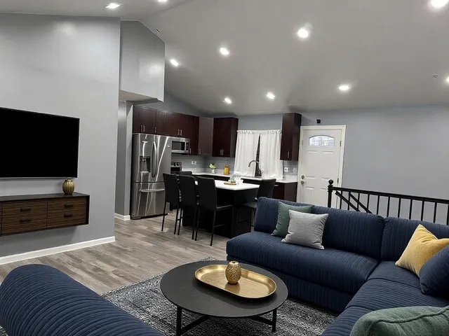 living room with lofted ceiling and light hardwood / wood-style floors