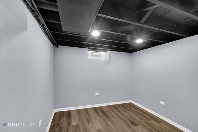 basement featuring wood-type flooring