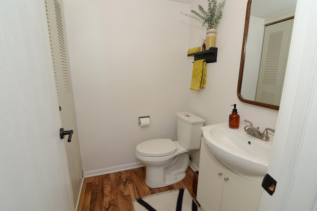 bathroom featuring vanity, hardwood / wood-style flooring, and toilet