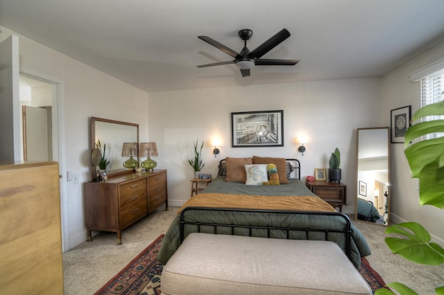 bedroom featuring light colored carpet and ceiling fan