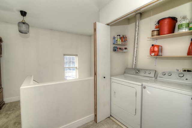 laundry room with washing machine and dryer and light carpet