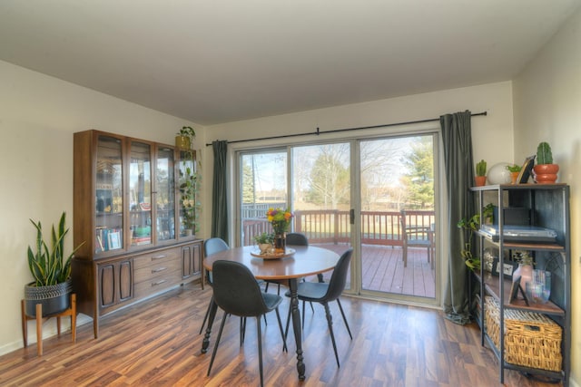 dining space with dark hardwood / wood-style floors