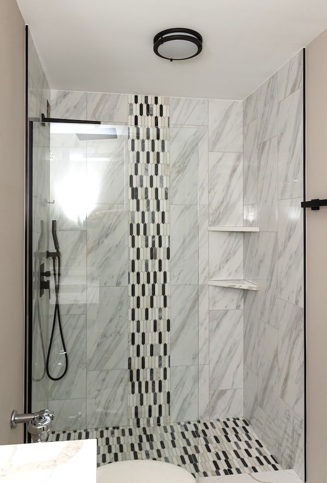 bathroom with a tile shower