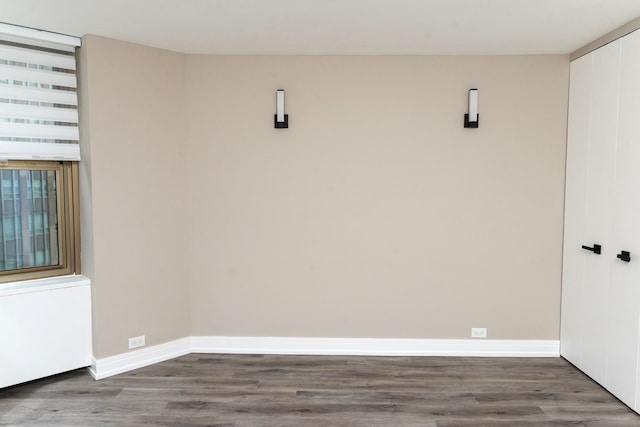 empty room featuring dark wood-type flooring