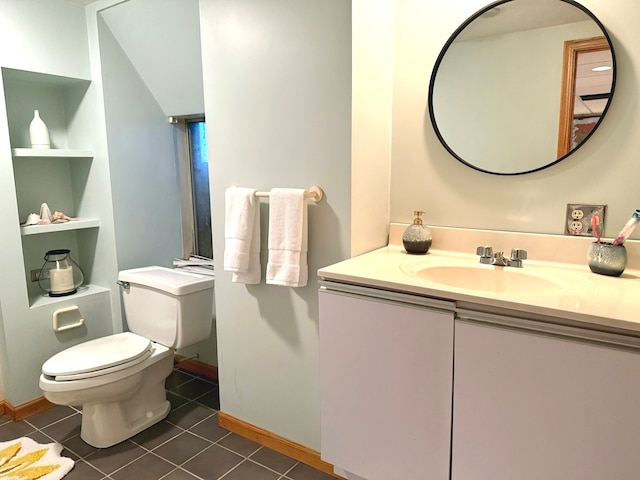 bathroom featuring tile patterned floors, vanity, and toilet