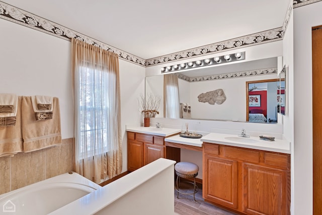 bathroom with vanity, hardwood / wood-style flooring, and a bathing tub