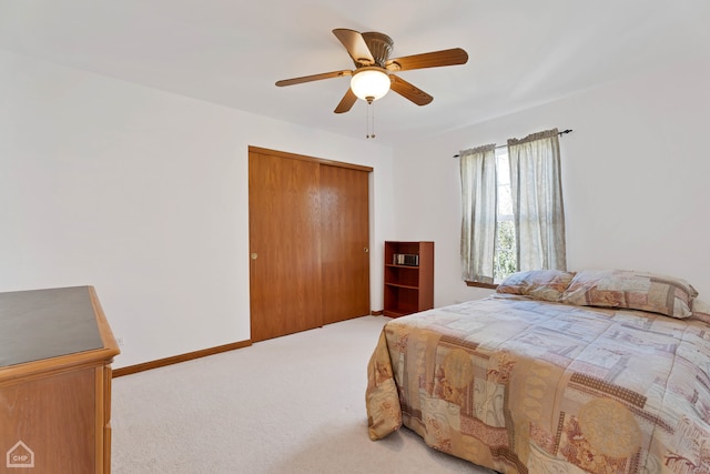 carpeted bedroom featuring a closet and ceiling fan