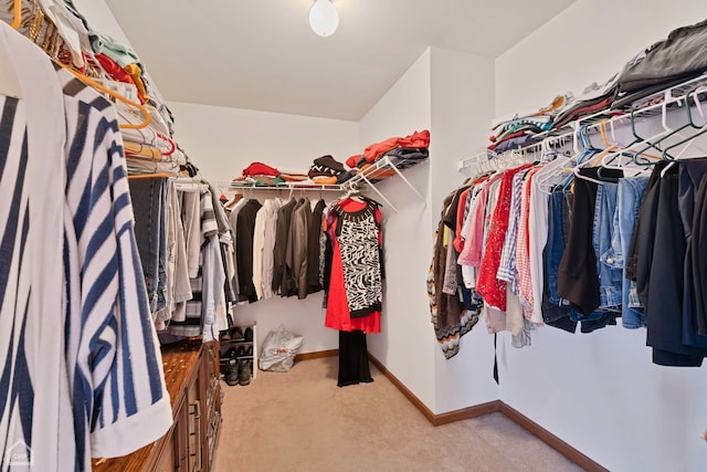 spacious closet featuring light carpet