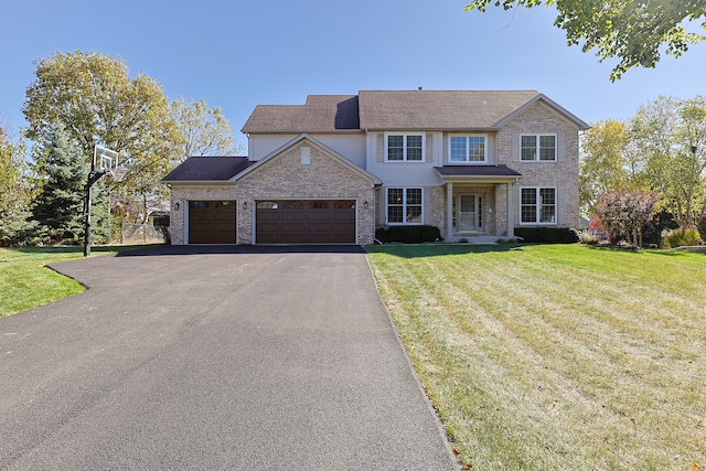 view of front of property featuring a front yard and a garage