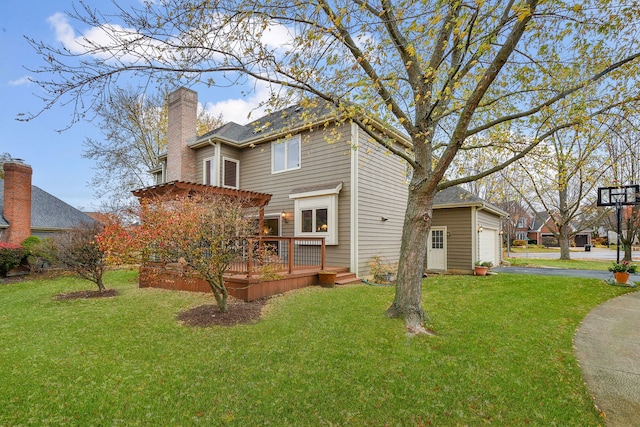 exterior space with an outbuilding, a deck, a yard, and a garage