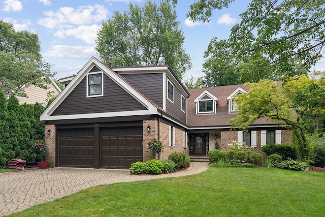 view of front of home featuring a front yard and a garage