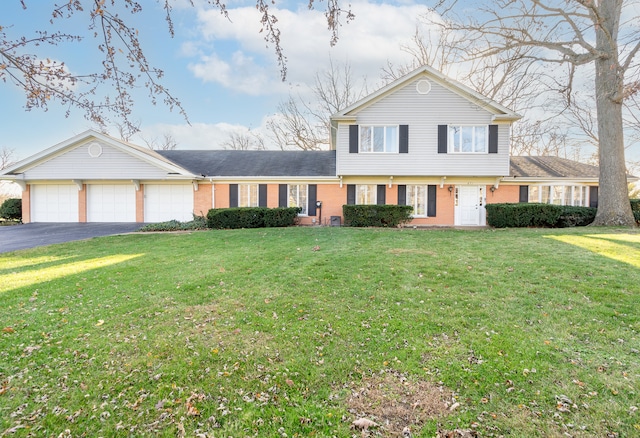 view of front of home with a garage and a front lawn