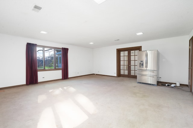 carpeted empty room with french doors