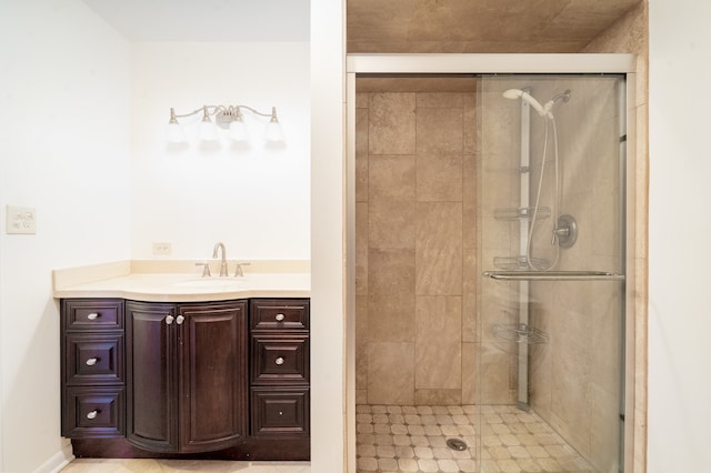 bathroom featuring vanity and a shower with shower door