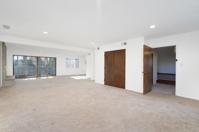 unfurnished room with light carpet