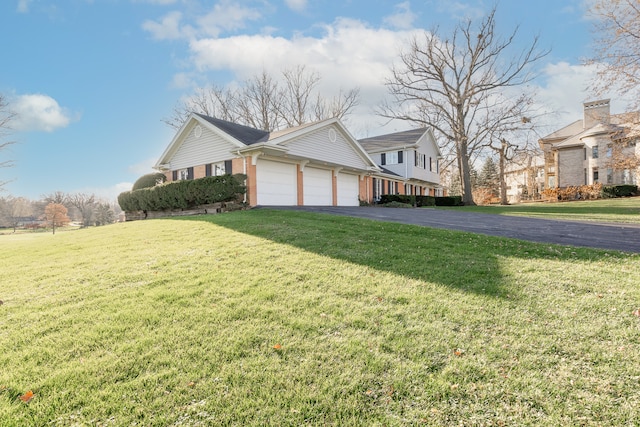 view of side of home featuring a yard and a garage