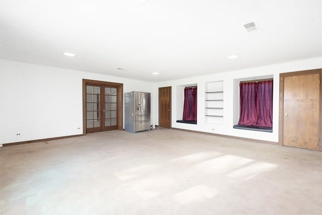 unfurnished bedroom with carpet, stainless steel fridge, and french doors