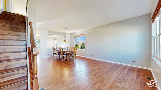 dining space with an inviting chandelier and light hardwood / wood-style floors