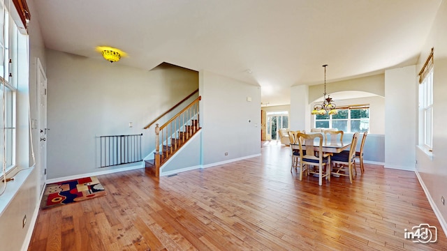 dining area featuring a notable chandelier and wood-type flooring