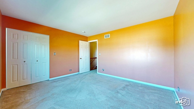 unfurnished bedroom featuring a closet and carpet floors