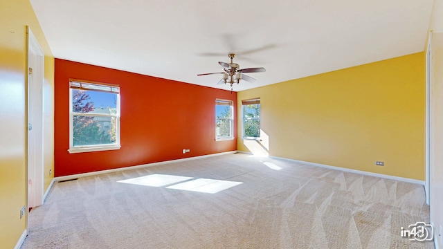 unfurnished room featuring light carpet and ceiling fan