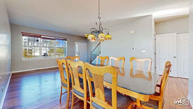 dining room featuring hardwood / wood-style floors and a notable chandelier