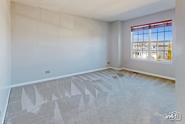 unfurnished room featuring carpet flooring