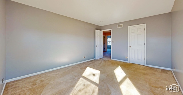 unfurnished bedroom featuring light carpet