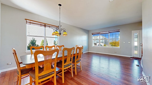 dining room featuring a notable chandelier and dark hardwood / wood-style flooring