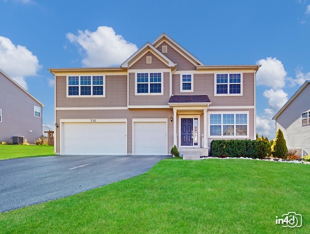 view of front of property with a front yard, central AC, and a garage