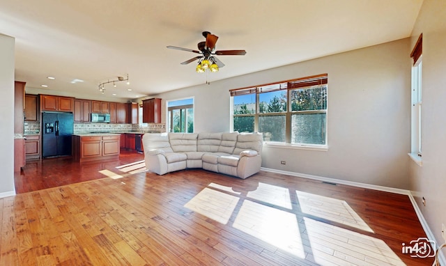 unfurnished living room with ceiling fan and hardwood / wood-style flooring