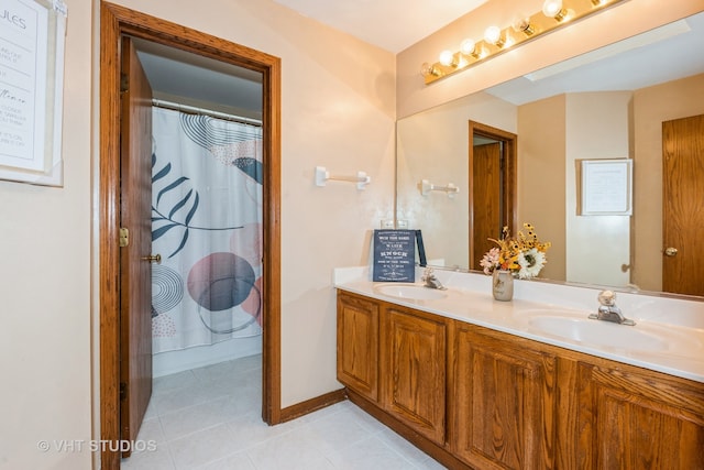 bathroom featuring tile patterned flooring, vanity, and walk in shower