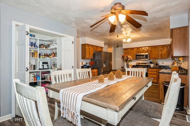 dining space with dark hardwood / wood-style flooring and ceiling fan