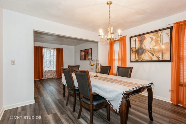 dining area featuring a chandelier and dark wood-type flooring