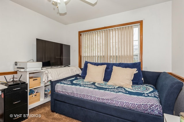 bedroom with ceiling fan and dark colored carpet