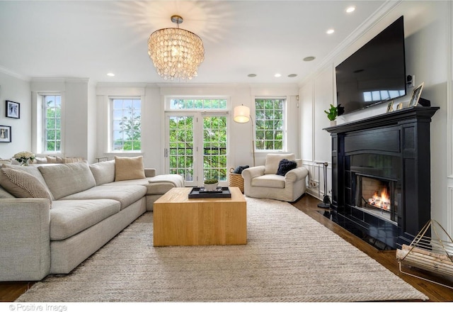 living room featuring ornamental molding, dark hardwood / wood-style floors, and a notable chandelier