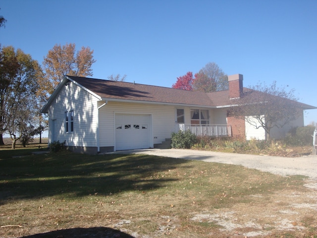 ranch-style home with a front yard and a garage