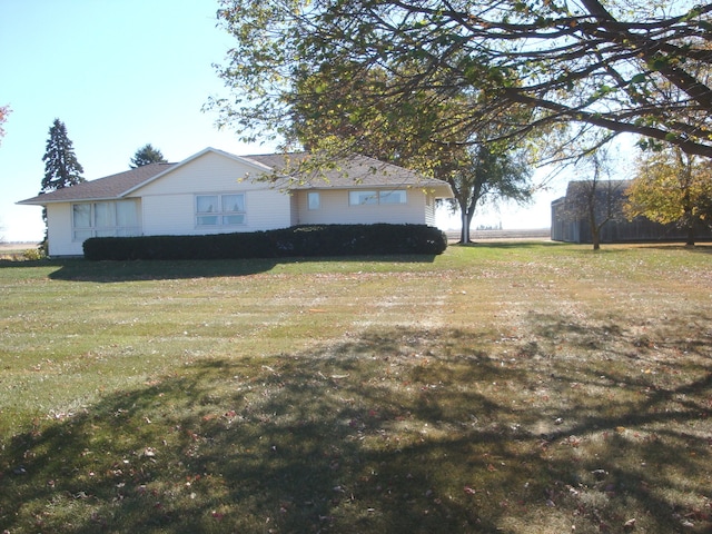 view of home's exterior with a lawn