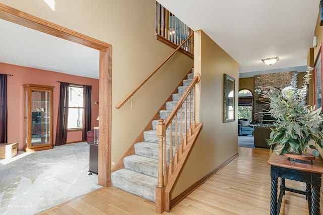 staircase featuring wood-type flooring