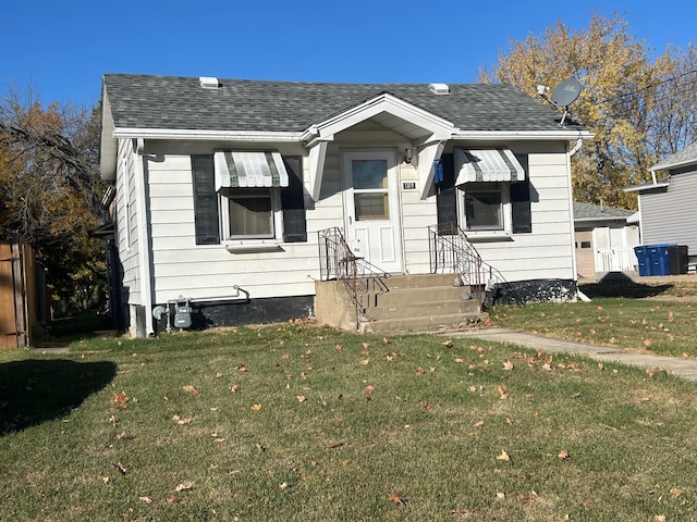 bungalow-style home with a front lawn