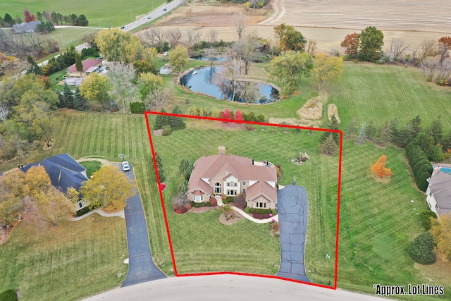 birds eye view of property with a water view and a rural view