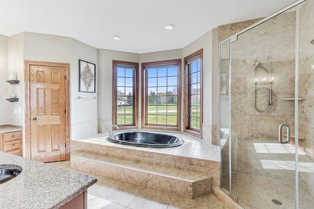 bathroom with tile patterned flooring, vanity, and independent shower and bath